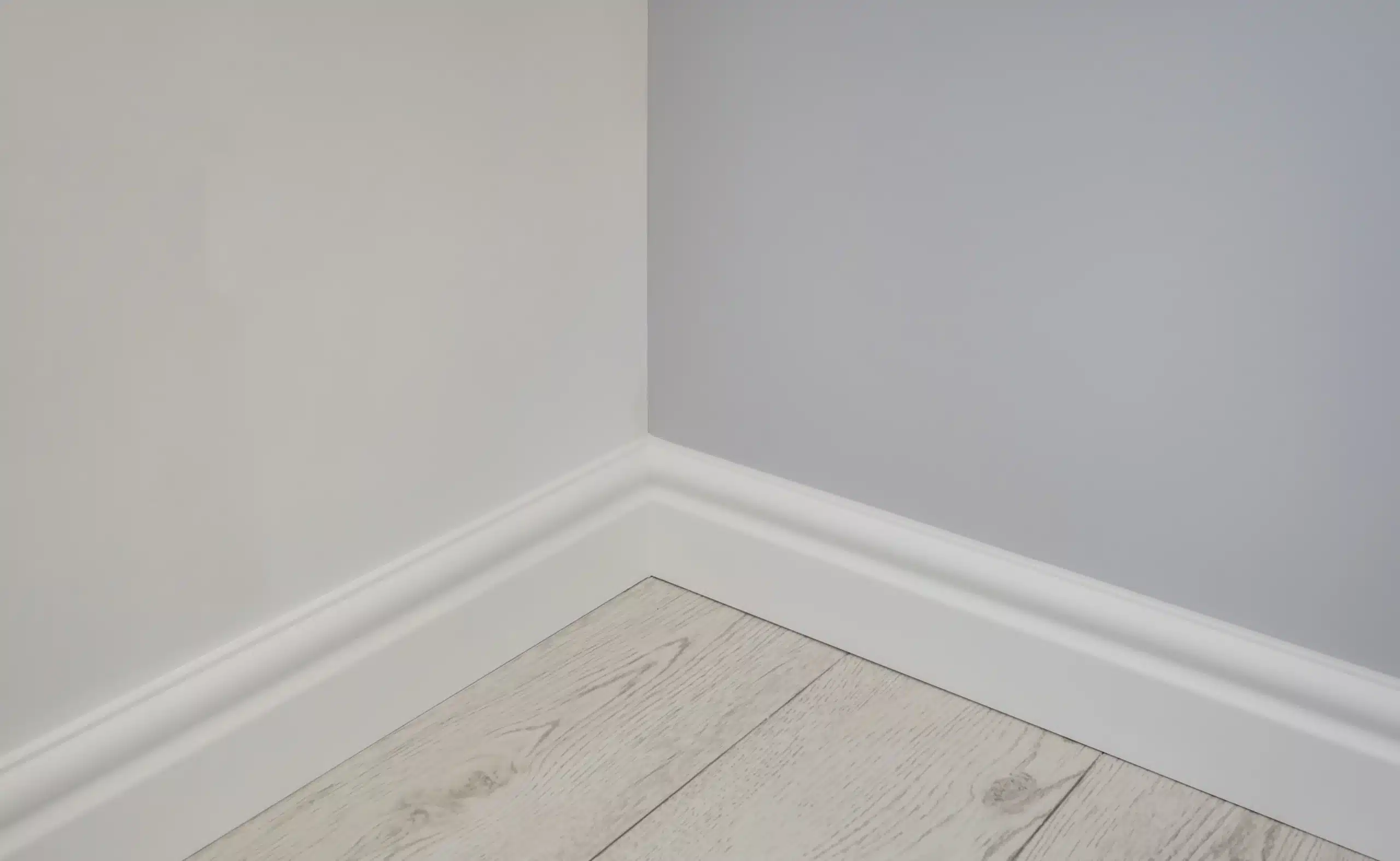 Wall after mold remediation — clean corner and baseboards